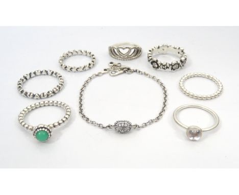 SEVEN PANDORA SILVER RINGSincluding gem set examples; and a Pandora silver chain link bracelet with central CZ set heart