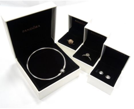 SELECTION OF NEW BOXED PANDORA JEWELLERYcomprising a silver charm bangle; a gem set silver ring; a rose openwork heart charm;