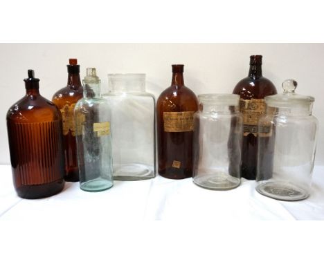 SELECTION OF EIGHT LARGE VINTAGE CHEMISTS BOTTLESsome with shaped tablet stoppers, one bottle marked Poison, four bearing con
