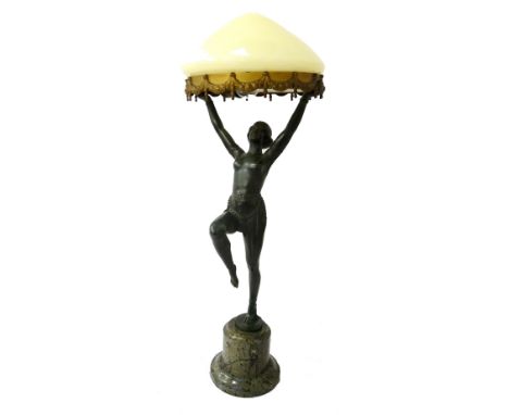 ART DECO FEMALE FIGURAL SPELTER TABLE LAMPthe semi-nude dancing figure with raised arms holding aloft a swag decorated ring, 