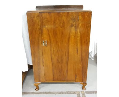 1930s WALNUT CUPBOARDthe single door with push-button release, shelved interior, raised on short cabriole legs, 119.5cm high 