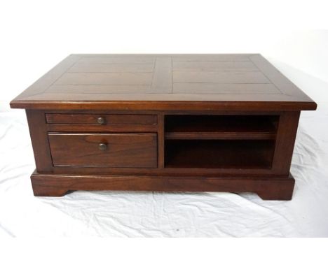 HEAVY OAK COFFEE TABLEthe oblong top over drawer and open shelf compartments either side, raised on plinth base, 41cm high x 