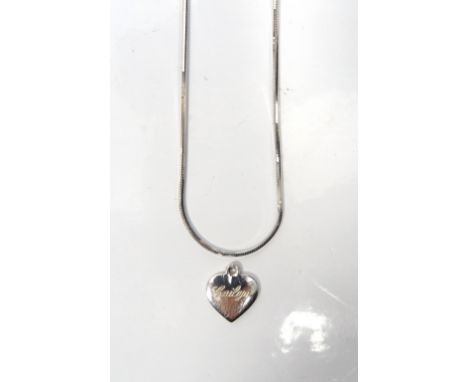 FOURTEEN CARAT WHITE GOLD HEART PENDANTand a fourteen carat white gold chain, the heart engraved 'Cailyn', total weight appro
