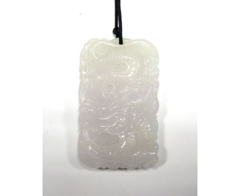 CARVED WHITE JADE PENDANTcarved with a dragon to one side and stylised bird to the other, approximately 4.9cm high