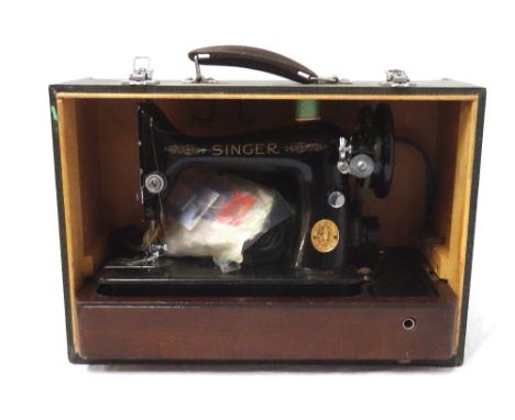 SINGER ELECTRIC SEWING MACHINEmodel number EG 013412, with attached light, various accessories and case