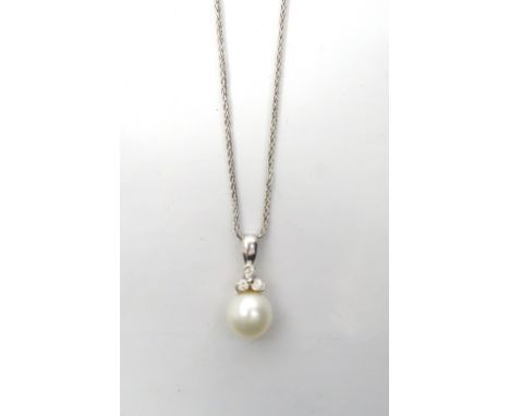 PEARL AND DIAMOND PENDANTthe single pearl below three diamonds, in fourteen carat white gold and on fourteen carat white gold