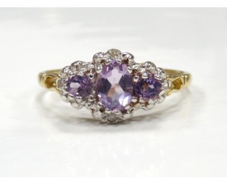 AMETHYST AND DIAMOND RINGthe three graduated amethysts with small diamonds around, on nine carat gold shank, ring size O