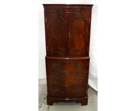 MAHOGANY COCKTAIL CABINETmodelled as a chest on chest, the upper section with double doors opening to reveal shaped shelving 