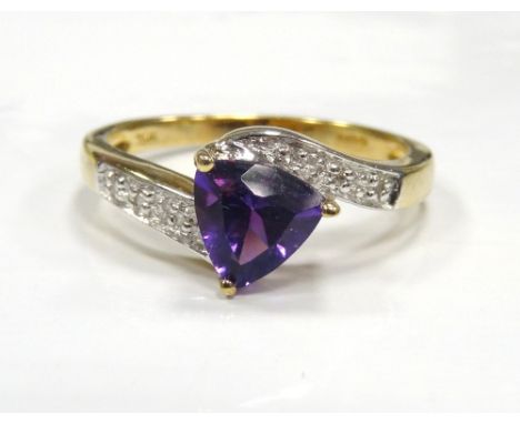 PURPLE GEM AND DIAMOND SET RINGthe trillion cut centre stone flanked by diamond set twist shoulders, on nine carat gold shank