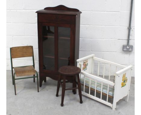 An oak floor-standing bookcase/cabinet with glazed door, a c1970s white painted wooden dolls' cot, a metal-framed bent lamina