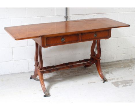 A modern yew wood sofa table with lined drawers to one side with two turned stretchers, when extended 74.5 x 140cm.