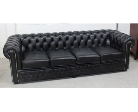 A large black four-seater Chesterfield sofa, approx length 230cm.