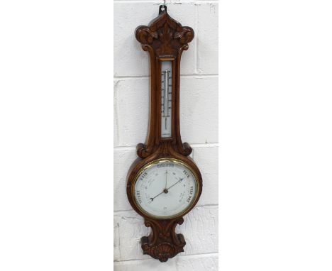 A late 19th/early 20th century oak-cased aneroid barometer/thermometer, height 82cm.