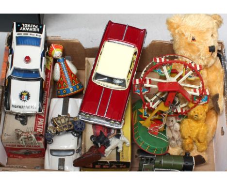 A quantity of vintage toys to include a c1950s straw-filled teddy bear, a wind-up train engine, a boxed battery-powered sedan