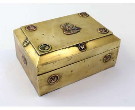 A Chinese brass box with hinged lid and circular cartouche enamel and brass relief decoration, length 18.5cm.