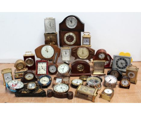 A quantity of clocks to include a c1950s oak-cased mantel clock, decorative clocks, small wall-hanging barometer, various bra