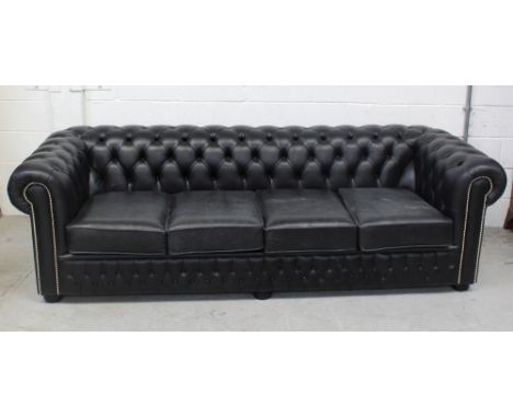 A large black four-seater Chesterfield sofa, approx length 237cm.