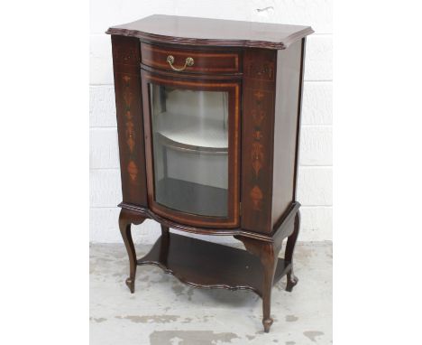 An early-to-mid 20th century bow-front inlaid display cabinet, one central bow-front glazed door, one lower shelf, to cabriol