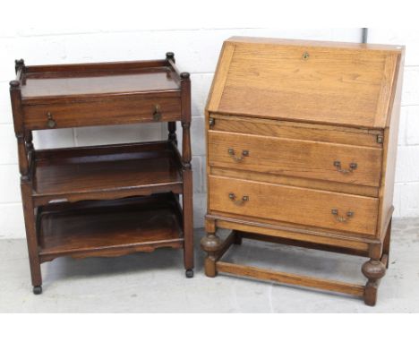 A mid-20th century oak bureau with fitted interior over two-drawer and bulbous leg base and an early-to-mid 20th century maho