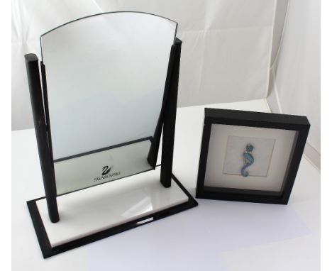 A shop display mirror advertising Swarovski Crystal, 49 x 28cm, a framed and glazed Swarovski Crystal figure of a cat and a n