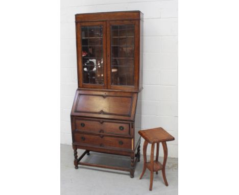 An early-to-mid 20th century oak bureau with associated elevated bookcase and a small late 1930s jardinière stand with shelf 