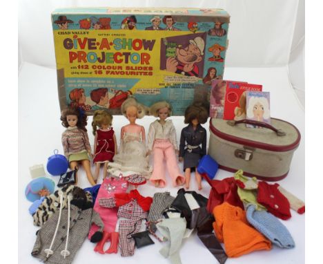 A boxed Chad Valley 'Give A Show' projector with colour slides, five plastic dolls, and a quantity of dolls clothing and acce