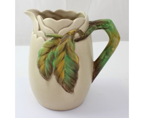 A Clarice Cliff for Wilkinson Ltd stone ground vase with naturalistic branch handle and moulded leaf decoration to body, appr