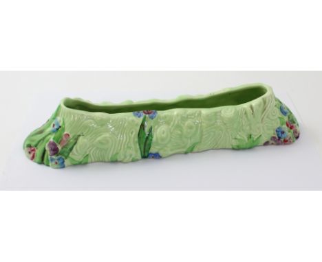 A Clarice Cliff for Newport Pottery posy trough with moulded tree bark decoration painted with pansies, Clarice Cliff for New