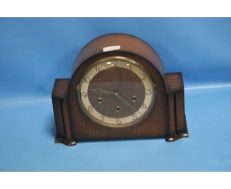 AN OAK MANTEL CLOCK