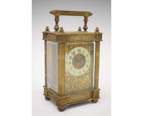 Early 20th Century brass cased carriage clock with timepiece movement, the cream Arabic dial surround by floral/ foliage gilt