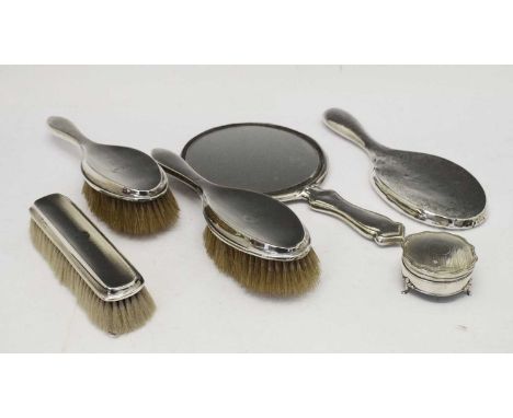 Three George VI silver dressing table brushes all engraved 'V.L.M.', Birmingham 1946, together with two silver mirrors and a 