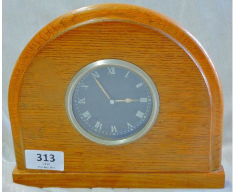A Clock-Which has been taken from the dashboard of a vintage motor car and mounted in an oak display stand, an unusual item w