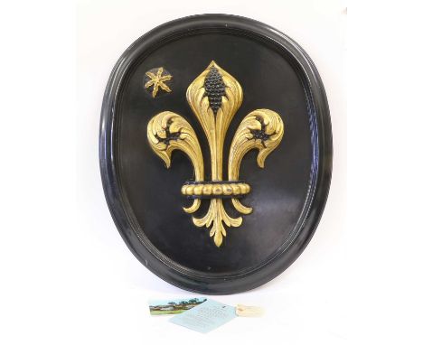 Of Royal Interest: A Gilt and Ebonised Wall Plaque, of oval form, carved and applied in high relief with a fleur de lys and s