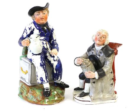 A Pearlware American Sailor Toby Jug, circa 1820, modelled seated upon a sea chest inscribed "Dollars", holding a clay pipe a