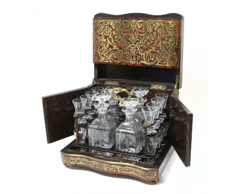 A French Boulle Travelling Decanter Set, circa 1860, of serpentine rectangular form, the hinged cover enclosing a lift-out tr