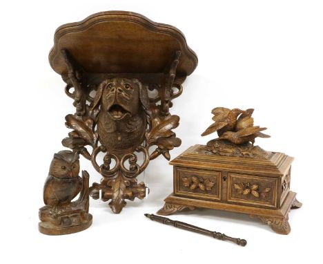 A Black Forest Carved Oak Wall Bracket, late 19th/20th century, the lobed demi-lune plinth over carved and pierced supports a