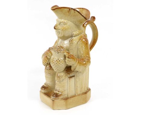 A Salt Glazed Stoneware Toby Jug, 19th century, possibly Brampton, modelled seated and holding a jug of foaming ale30cm highF