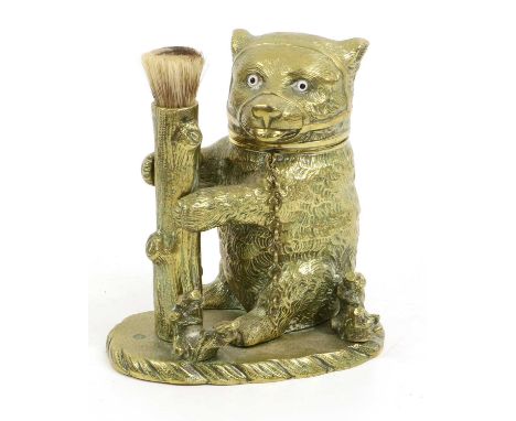 A Victorian Brass Novelty Inkwell, in a form of a seated bear with glass eyes, the hinged head enclosing an inkwell next to a