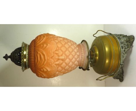 A Victorian Veritas oil lamp with original cast iron top above unusual moulded glass shade, brass reservoir on openwork cast 
