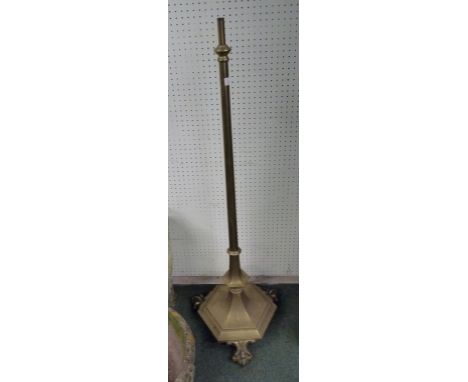An adjustable brass standard lamp on octagonal base, with Roccoco scroll feet.  164 cm height approx.