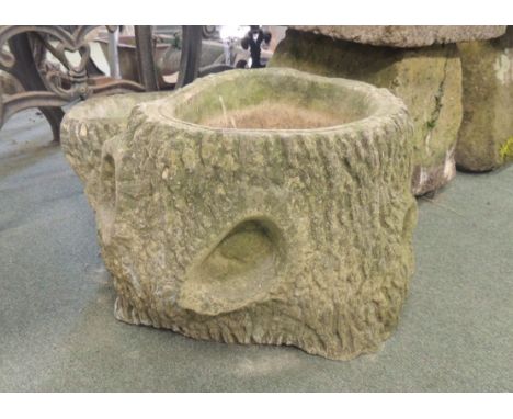 A modern bark effect concrete planter 