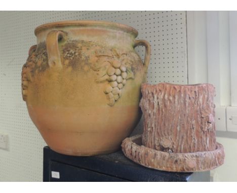 A large terracotta planter 44cm high and a bark effect terracotta planter and saucer 