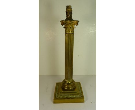 An early 20th Century brass Corinthian column table lamp with weighted base,  40.5cms high not including lamp fitting