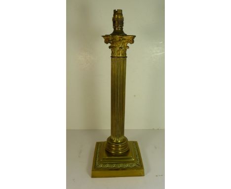 An early 20th Century brass Corinthian column table lamp with weighted base,  40.5cms high not including lamp fitting