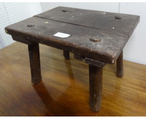 A 19th Century, oak milking stool.  34cm length x 27cm depth x 24cm height approx. 