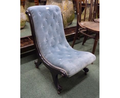 A Victorian ebonised and gilt line decorated nursing chair.  Button back blue upholstery, and on ceramic castors. 46 cm width