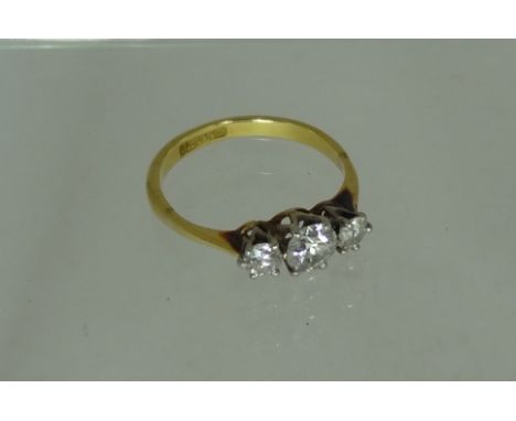 A ladies 18ct gold and platinum mounted three stone diamond ring.  The central stone half carat approx with quarter carat eit