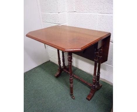 A late Victorian walnut Sutherland table, the table leaves with canted corners on turned legs and support and with ceramic ca