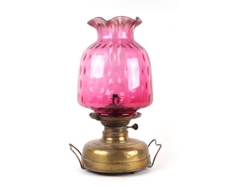 A Victorian glass oil lamp with cranberry glass shade, approx 47cms high.Condition ReportThe shade has a small chip to the un