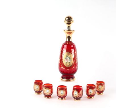 A Murano ruby glass liquor set comprising decanter and six glasses with enamelled floral decoration and gilt highlights (7).